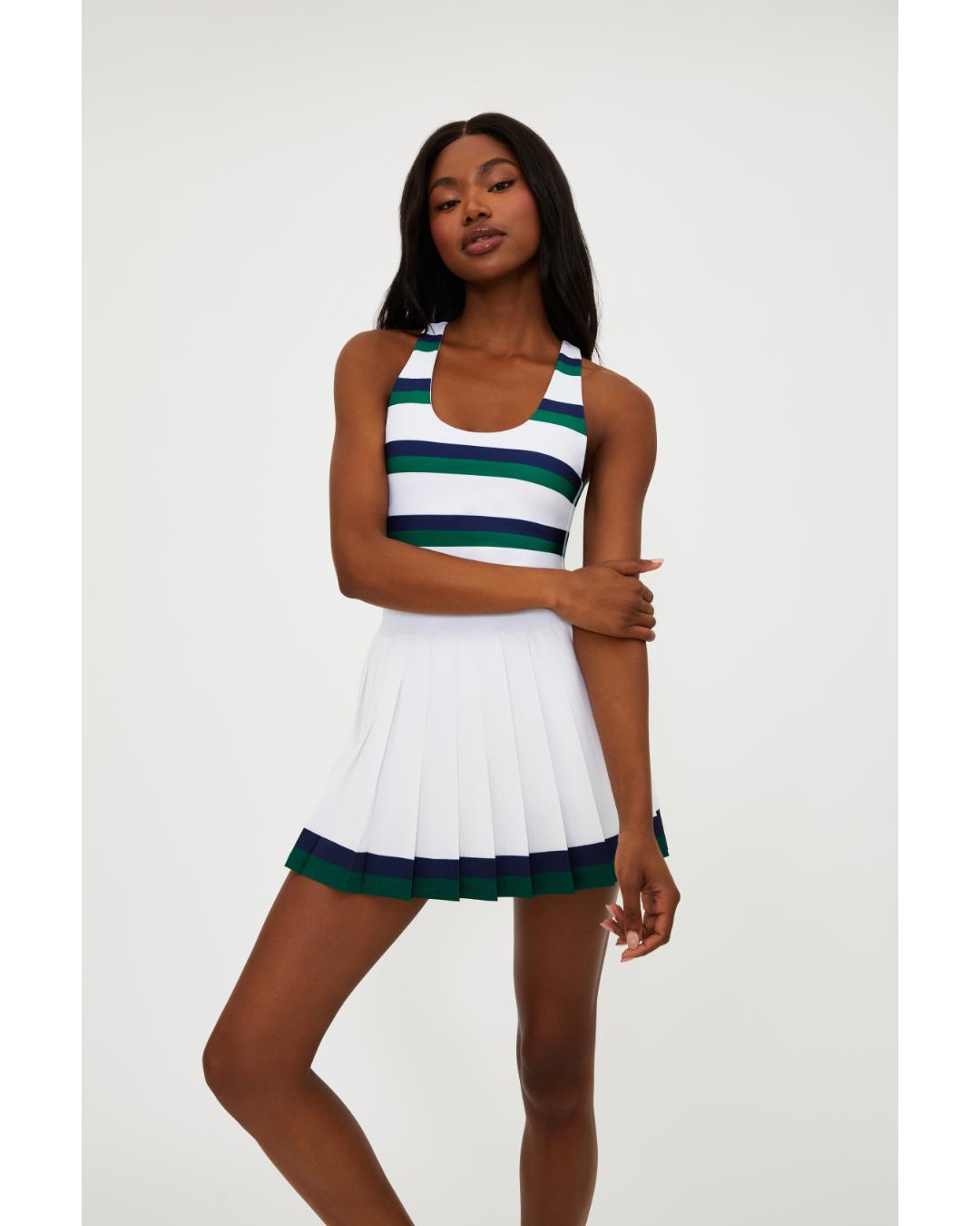 white pleated tennis skirt with navy and green stripe around the bottom