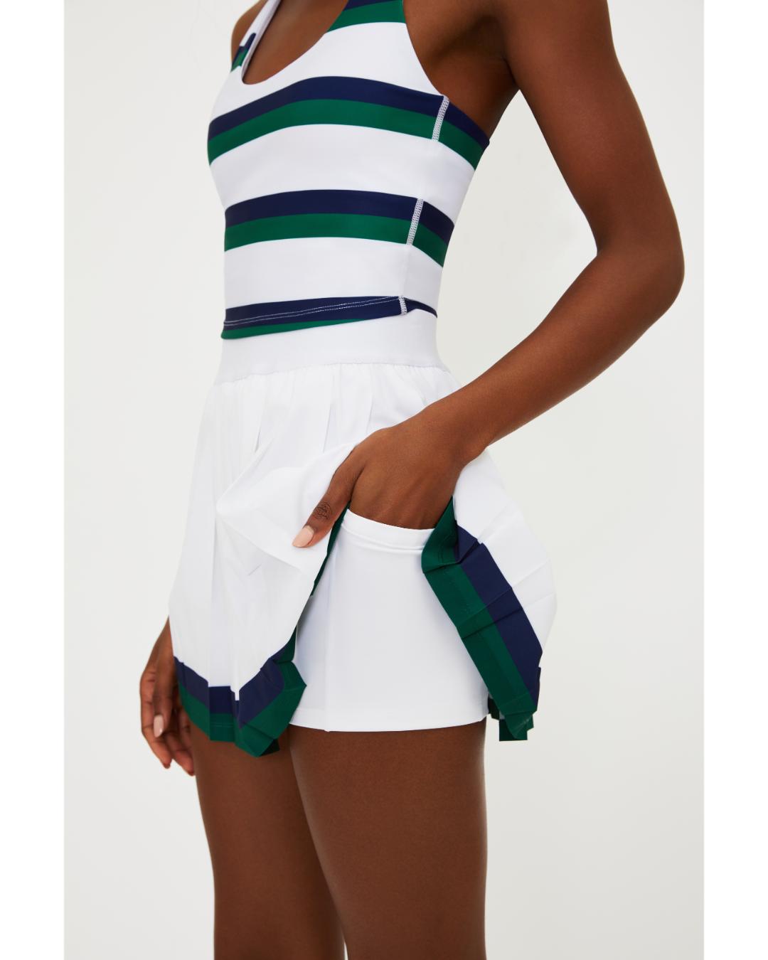 white pleated tennis skirt with navy and green stripe around the bottom