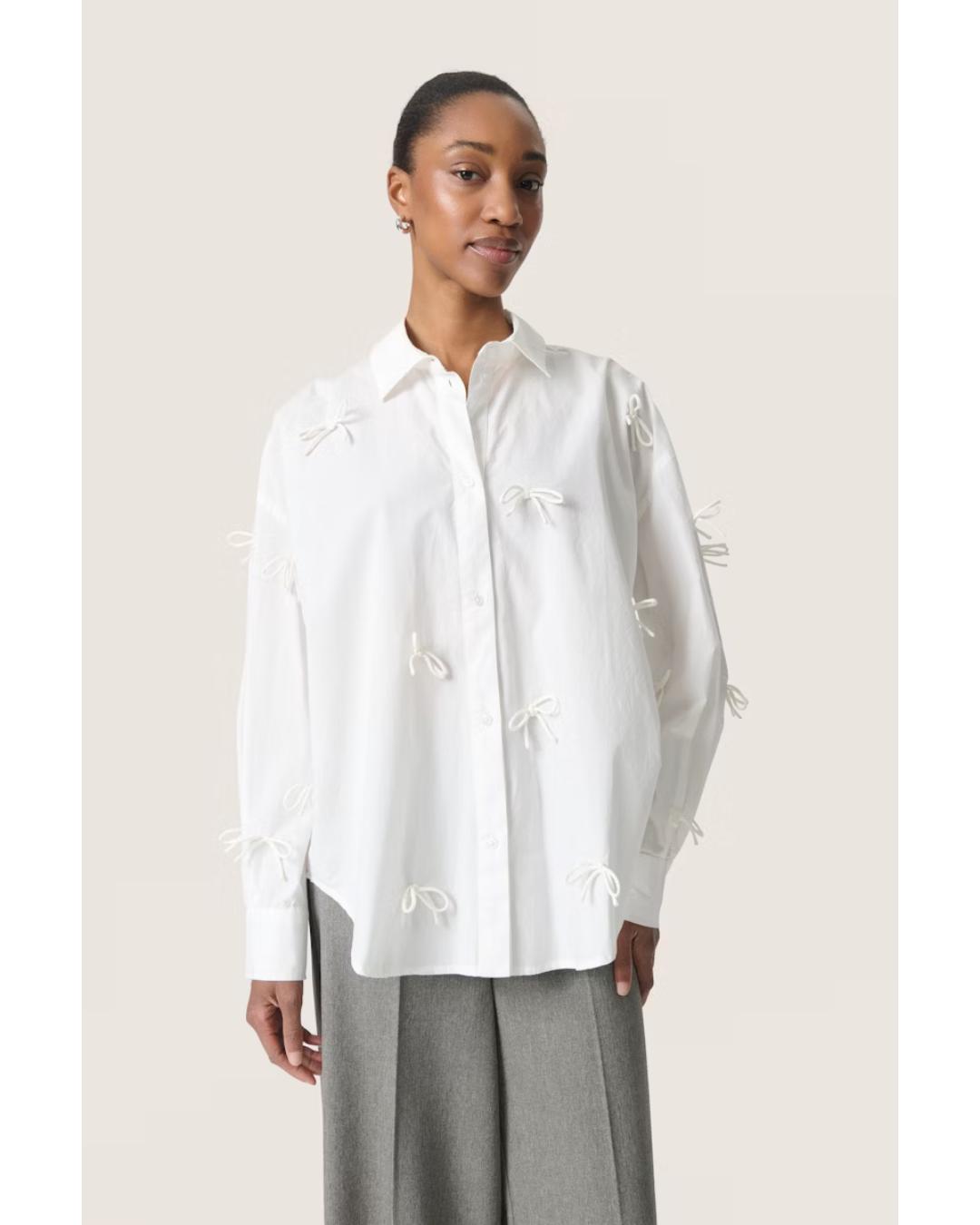 white blouse with bows all over 