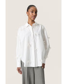 white blouse with bows all over 