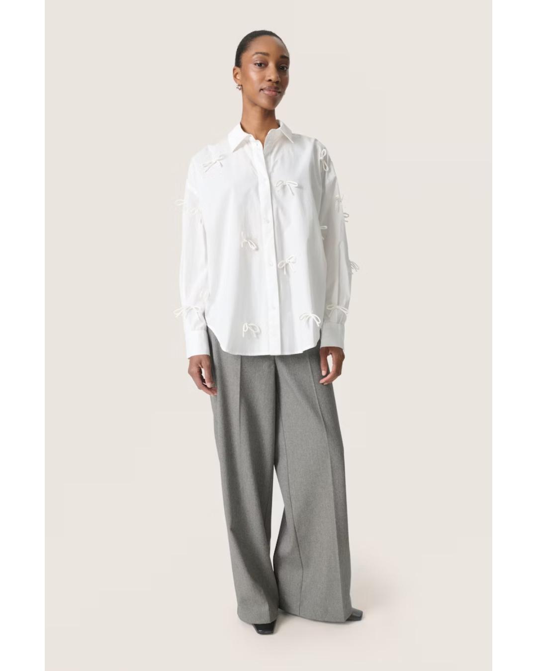 white blouse with bows all over 