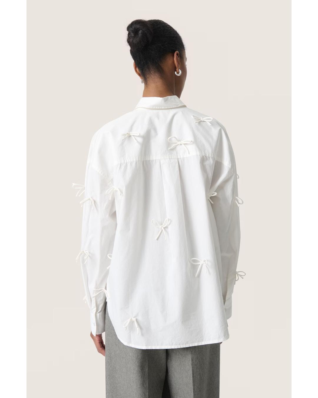 white blouse with bows all over 