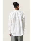 white blouse with bows all over 