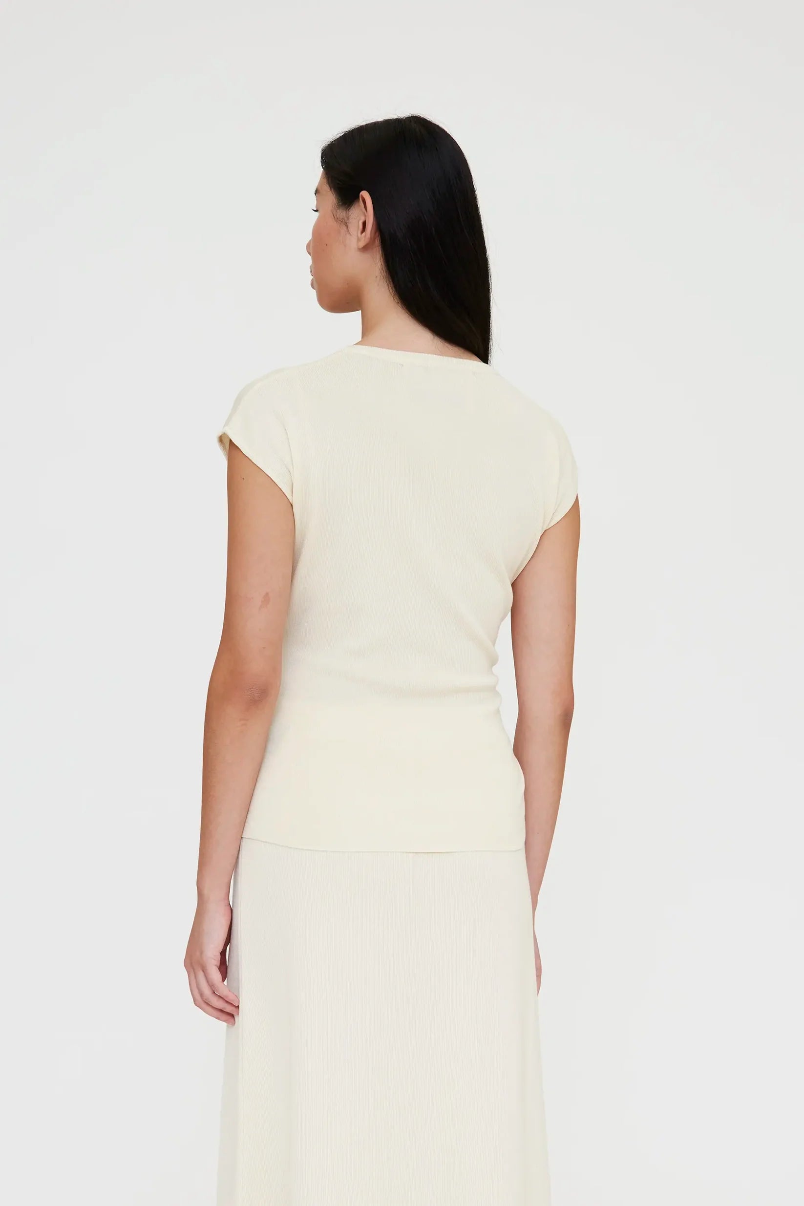off white shirt sleeve cardigan with a large tie in the front