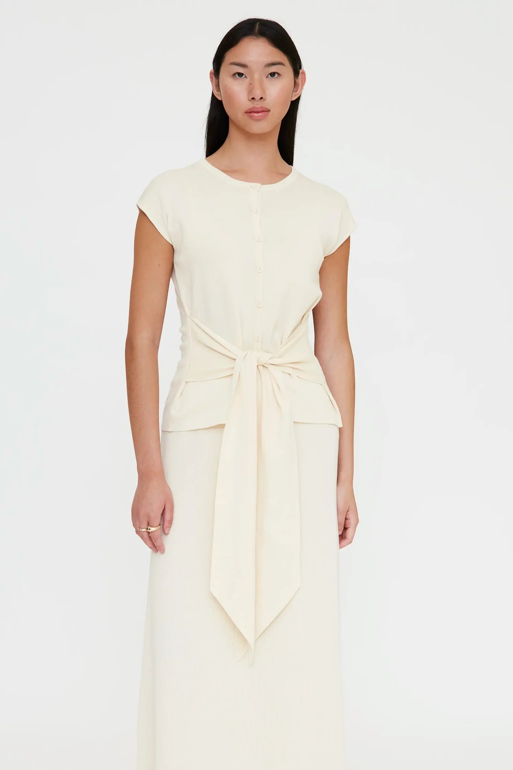 off white shirt sleeve cardigan with a large tie in the front