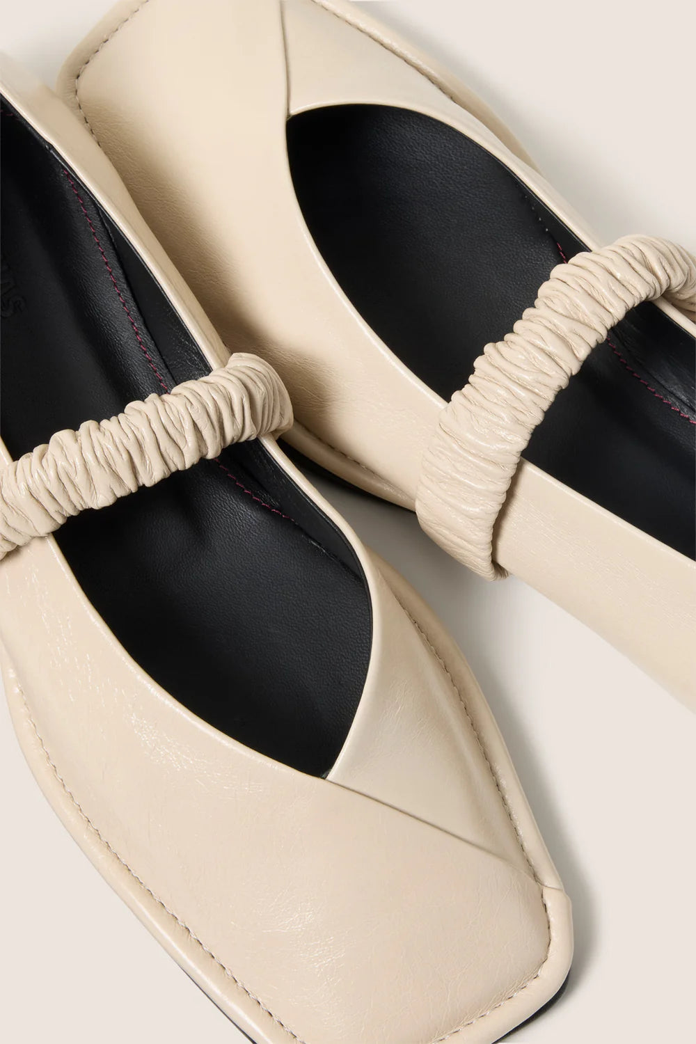 cream leather ballet flat with a square toe and a ruched strap