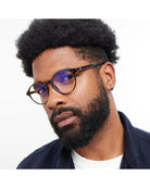 round eyeglasses with a tortoise frame