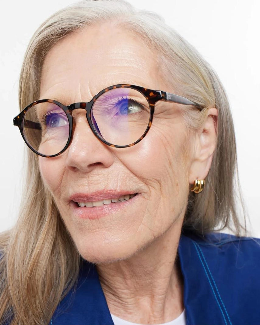 a woman wears a pair of round framed tortoiseshell eyeglasses for blue light by Barner