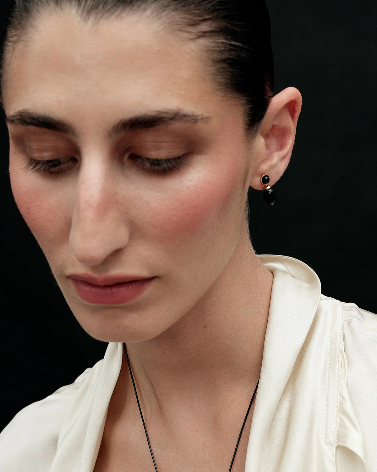black drop earring with gold accents