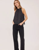 black sleeveless top with white polka dots