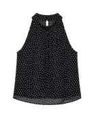 black sleeveless top with white polka dots