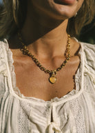gold chain necklace with light pink heart pendant 
