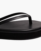 black flip flop with a platform