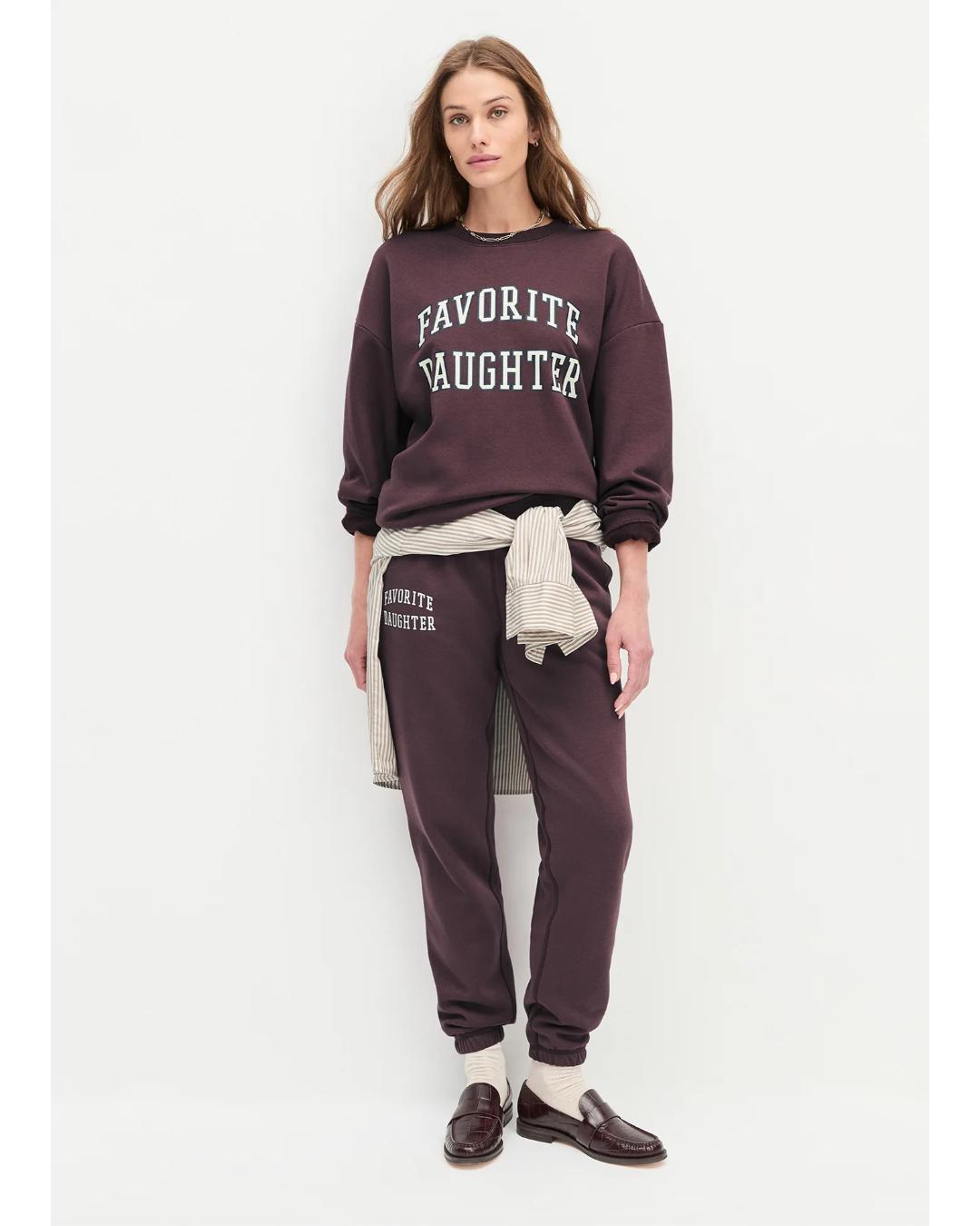 burgundy sweatpants with the text favorite daughter on the side of the leg