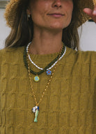 long gold chain necklace with a fish pendant