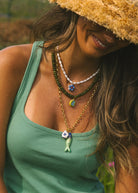 long gold chain necklace with a fish pendant