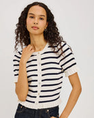 short sleeve sweater with white and navy stripes and a ruffle on the bottom of skirt and sleeves