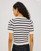 short sleeve sweater with white and navy stripes and a ruffle on the bottom of skirt and sleeves