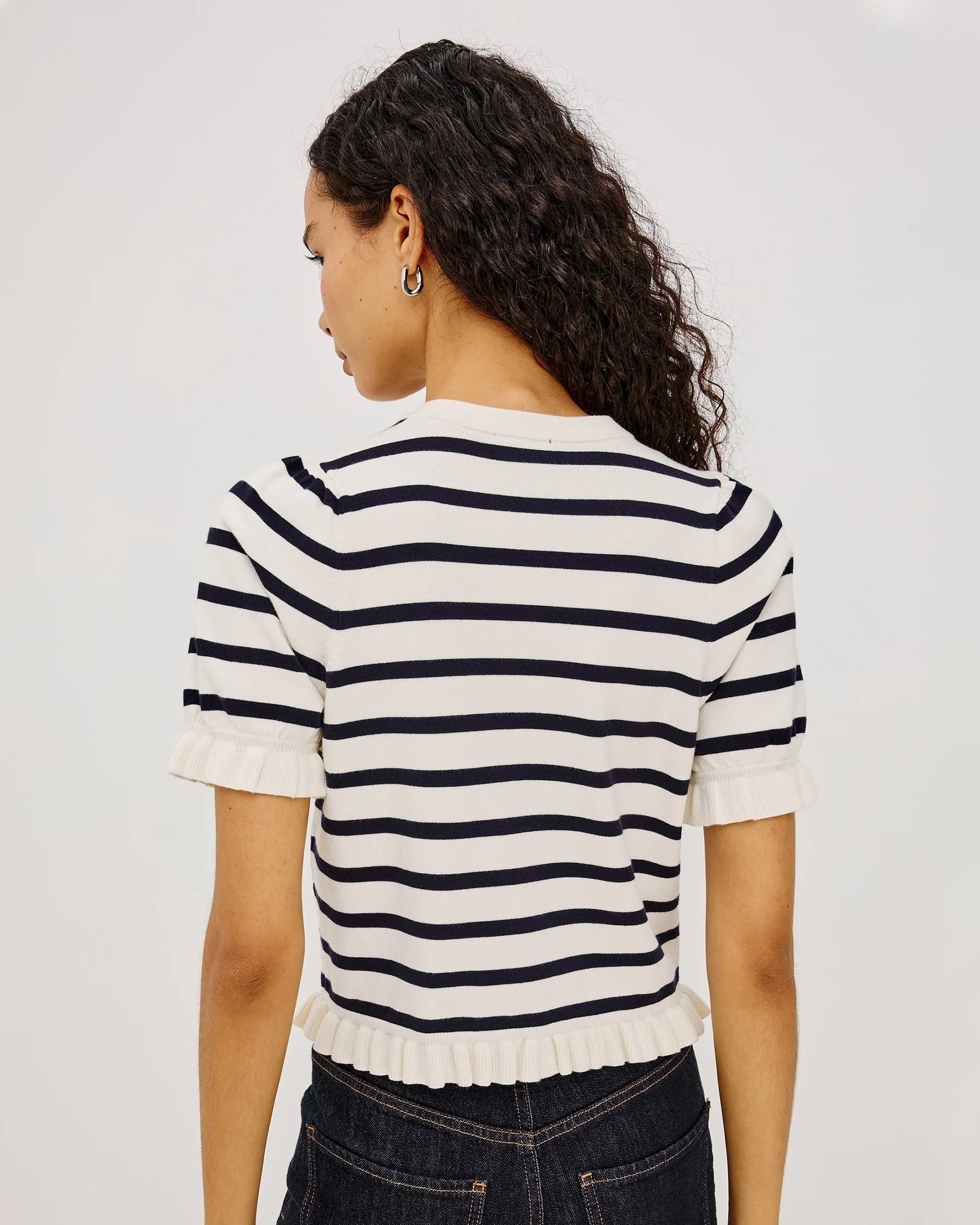 short sleeve sweater with white and navy stripes and a ruffle on the bottom of skirt and sleeves