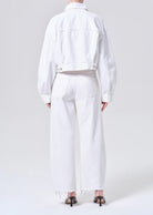 white denim pants with a curve shape and a fray bottom