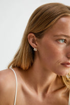 chunky gold earring with diamond in the middle