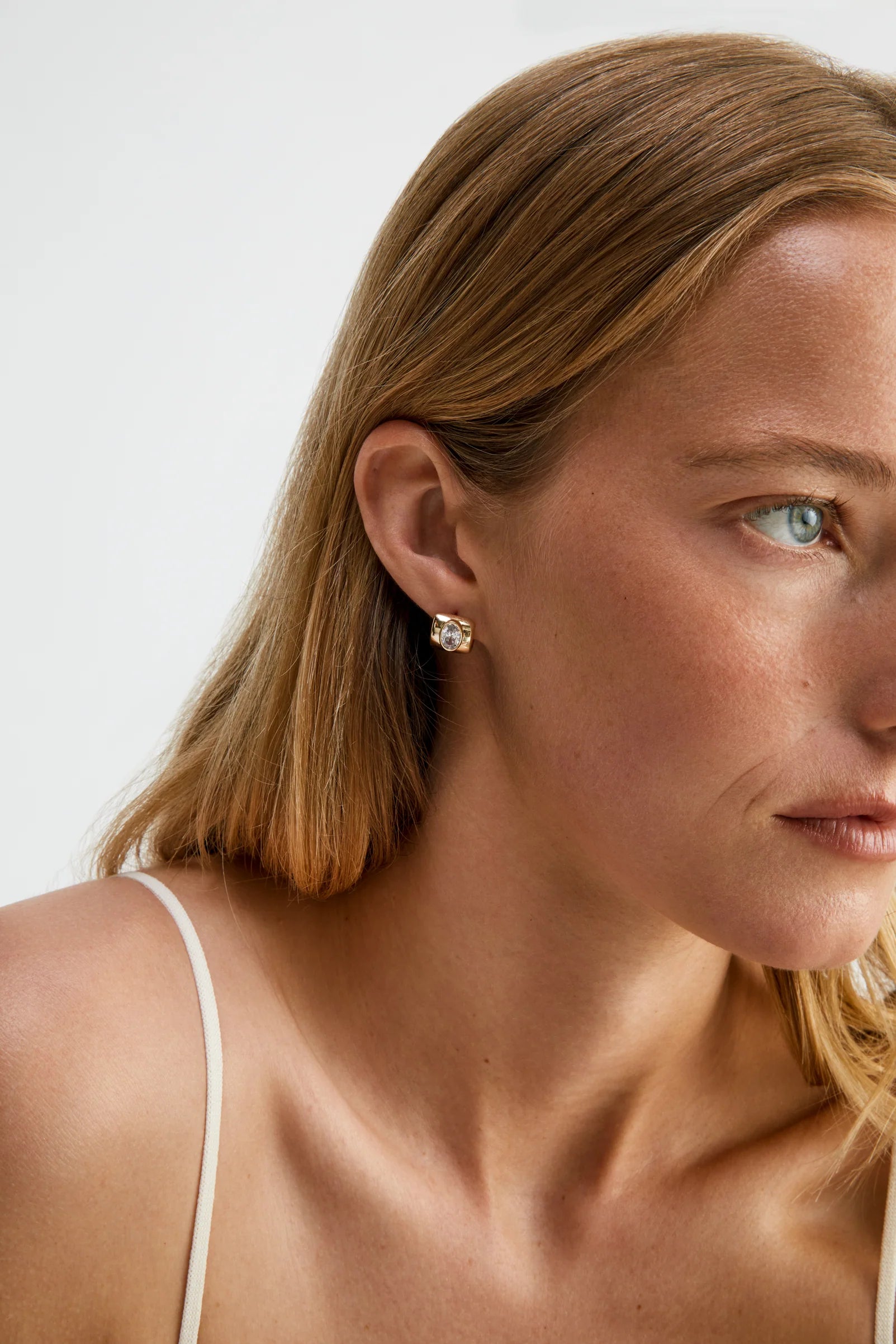 chunky gold earring with diamond in the middle
