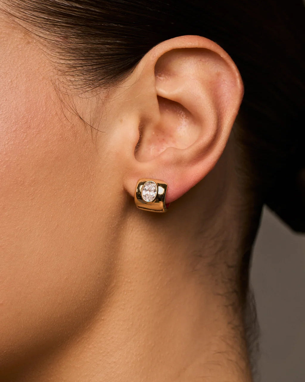 chunky gold earring with diamond in the middle