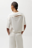 off white crop top with slit in the back
