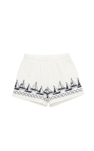 white lounge shorts with navy sailboats on the bottom 