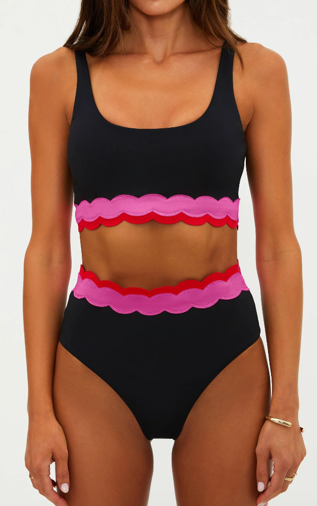 black sports bra with pink and red detail on the bottom