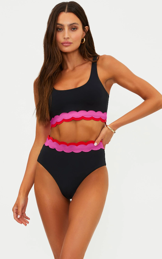 black sports bra with pink and red detail on the bottom