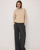 beige cardigan with a rolled hem