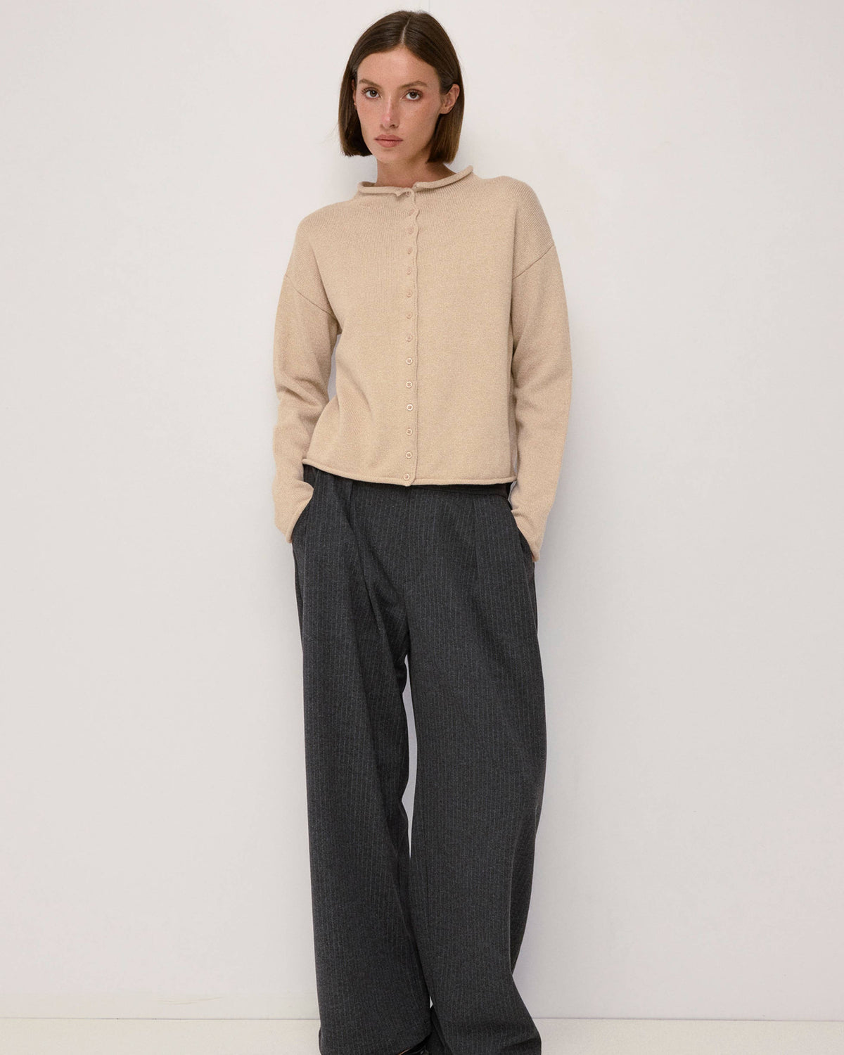 beige cardigan with a rolled hem