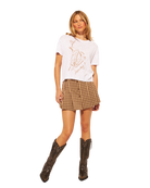white t-shirt with brown cowboy boots and a martini design on the front