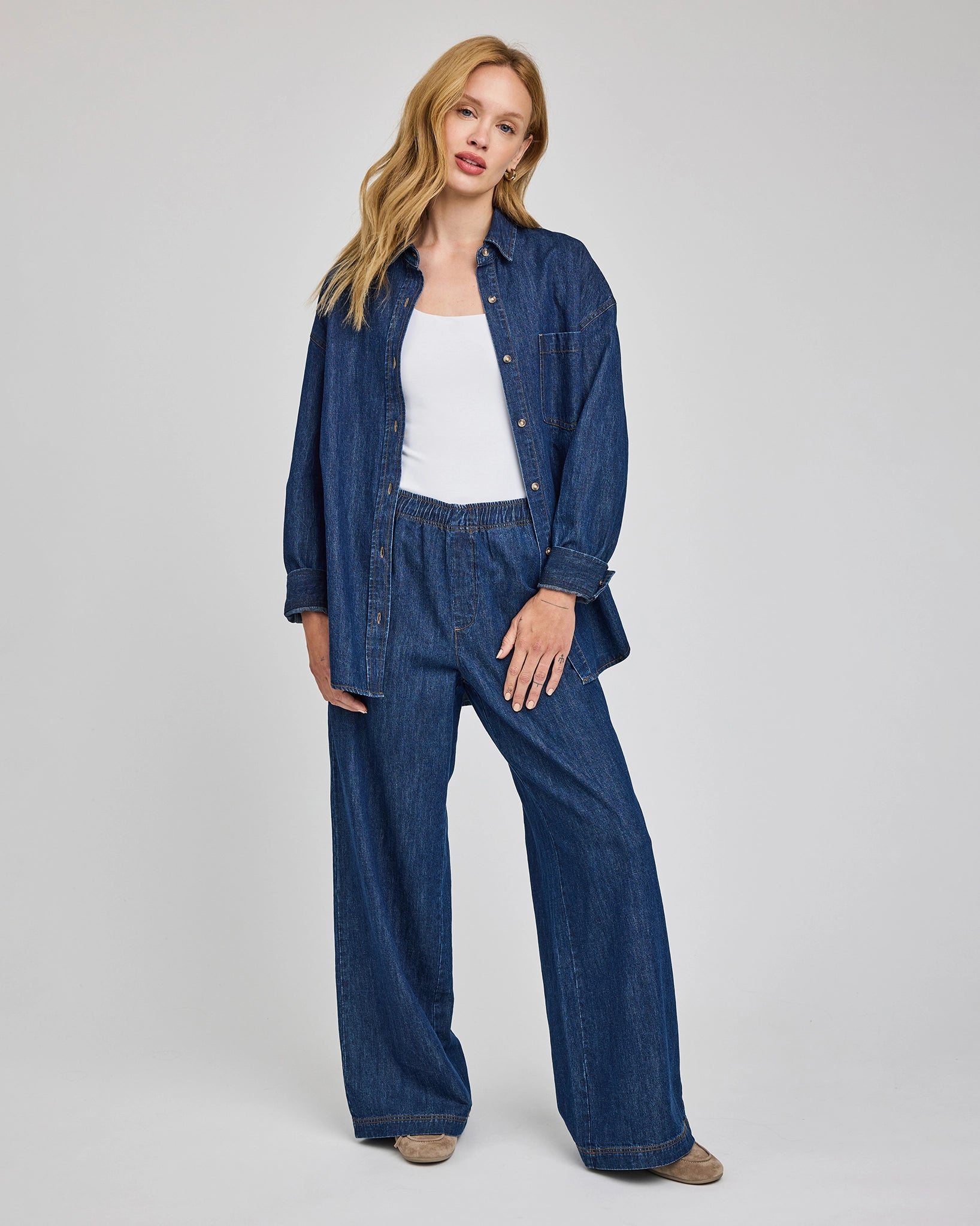 a woman wears a pair of wide leg denim jeans with elastic waist and matching shirt