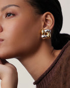 accent earring in a woven design with silver and gold