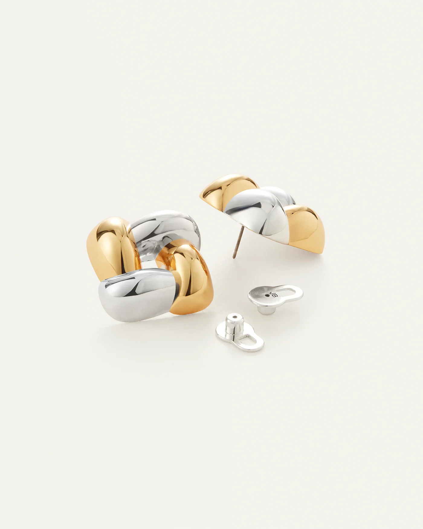 accent earring in a woven design with silver and gold