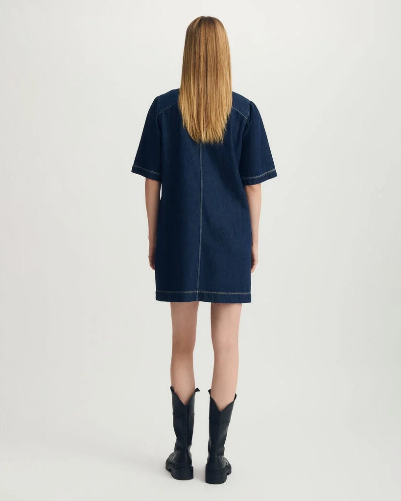 Woman wearing a blue denim dress with black boots