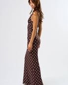 side view of a maxi dress in brown with white polka dots
