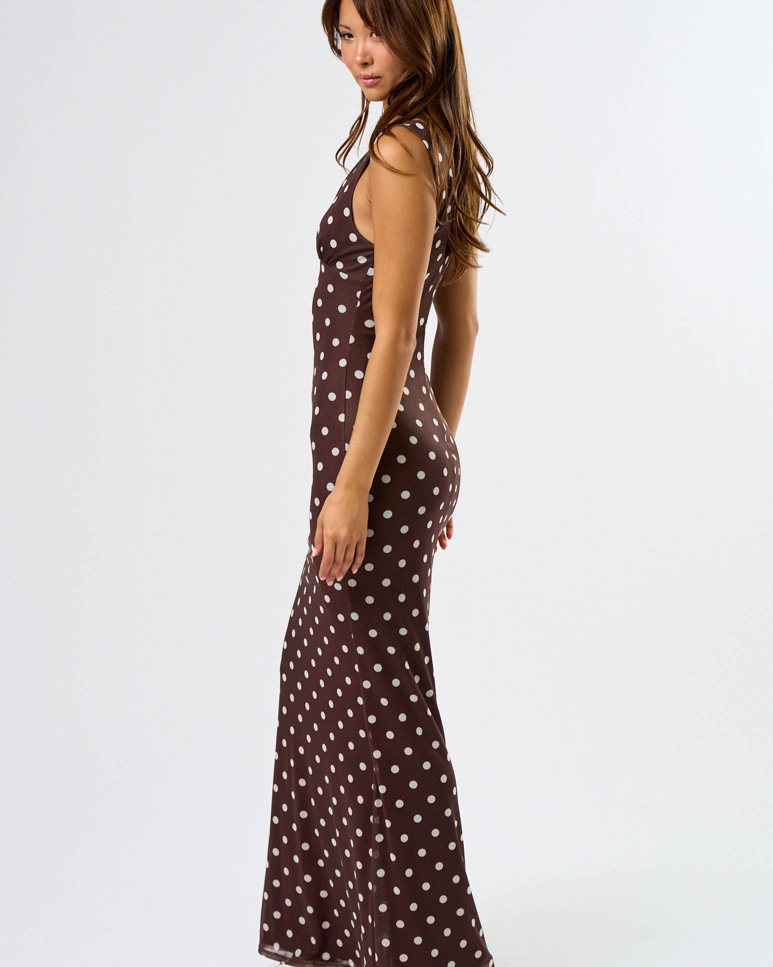 side view of a maxi dress in brown with white polka dots