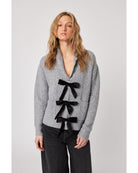 grey cardigan with three black bows down the front