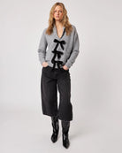 grey cardigan with three black bows down the front