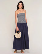 strapless midi dress with navy stripes on top and a drop waist bottom