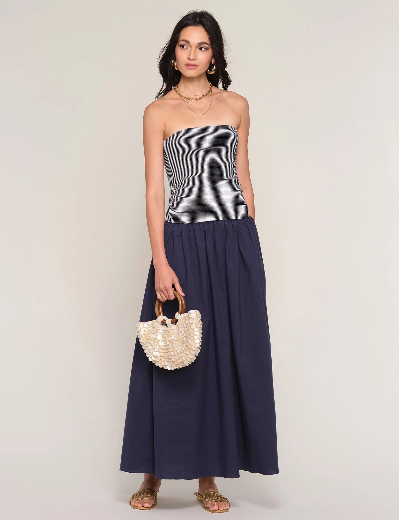 strapless midi dress with navy stripes on top and a drop waist bottom