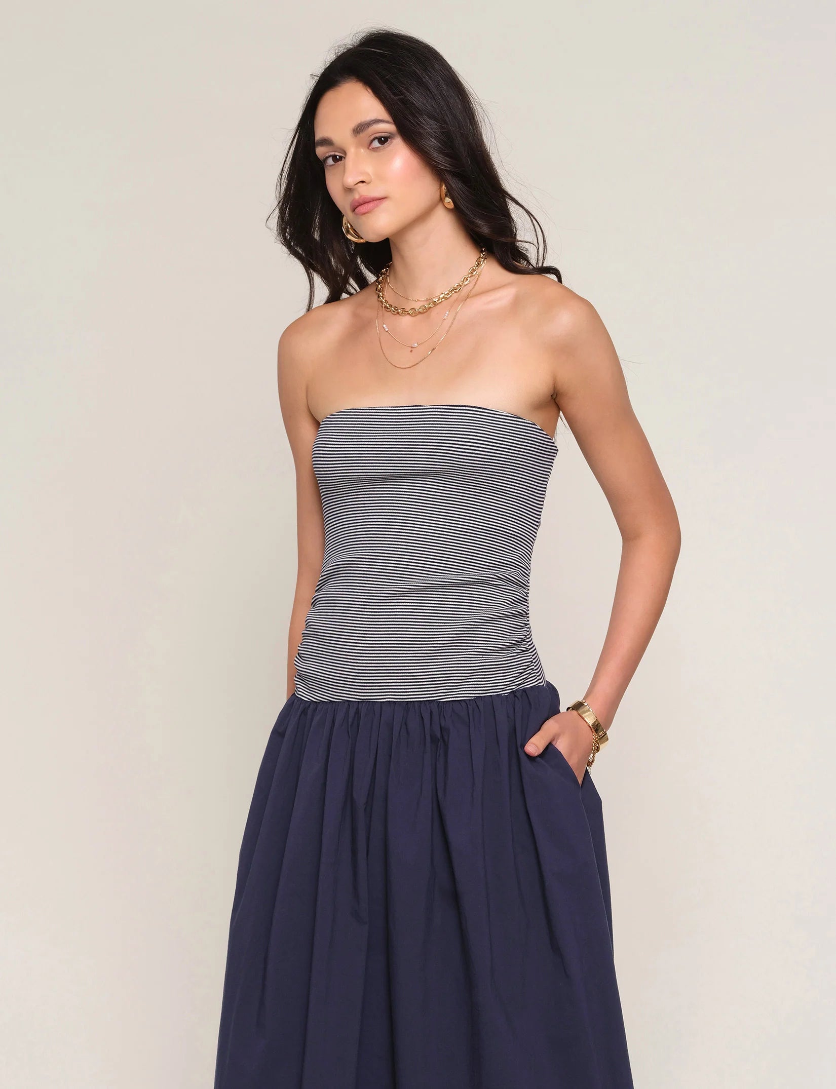 strapless midi dress with navy stripes on top and a drop waist bottom