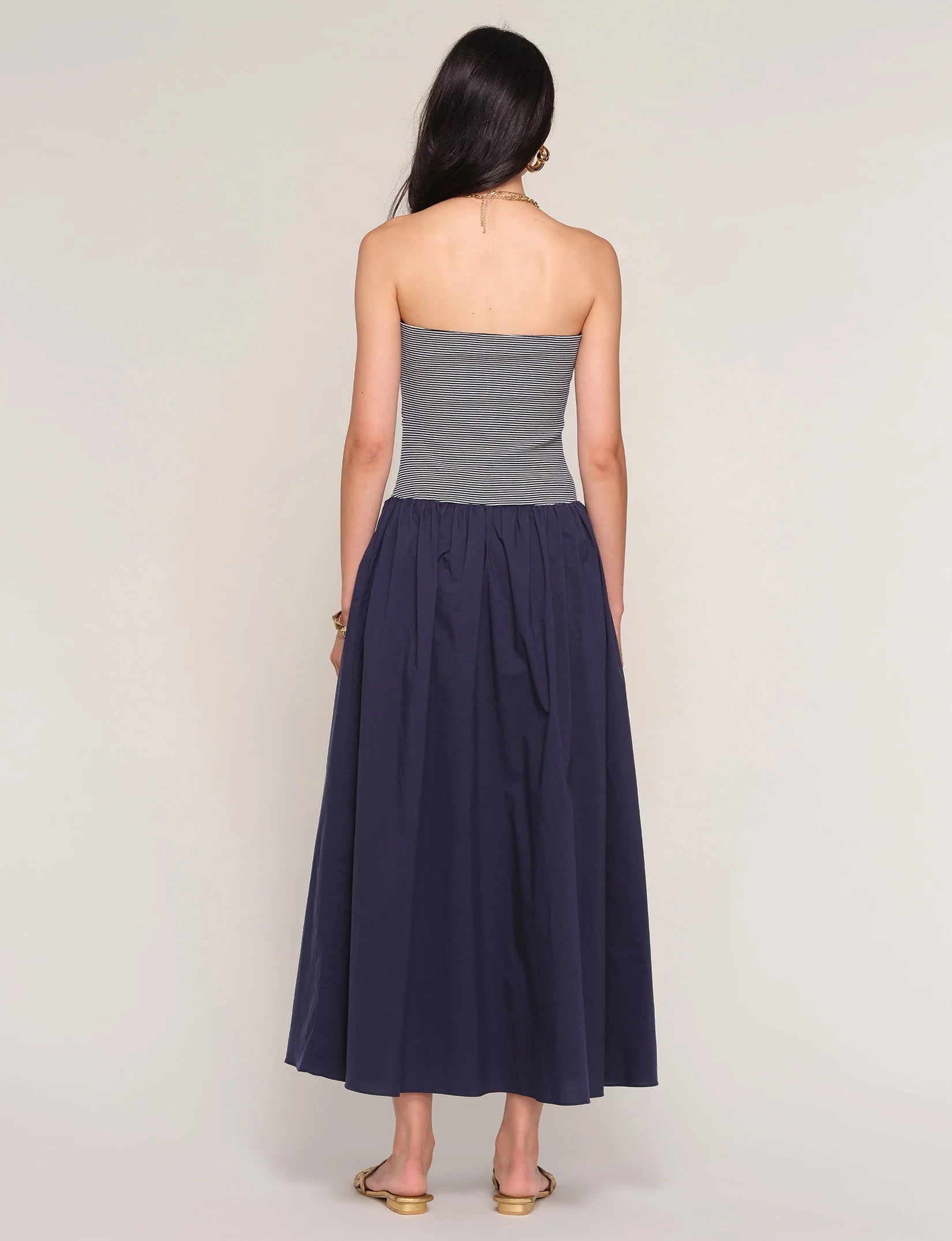 strapless midi dress with navy stripes on top and a drop waist bottom