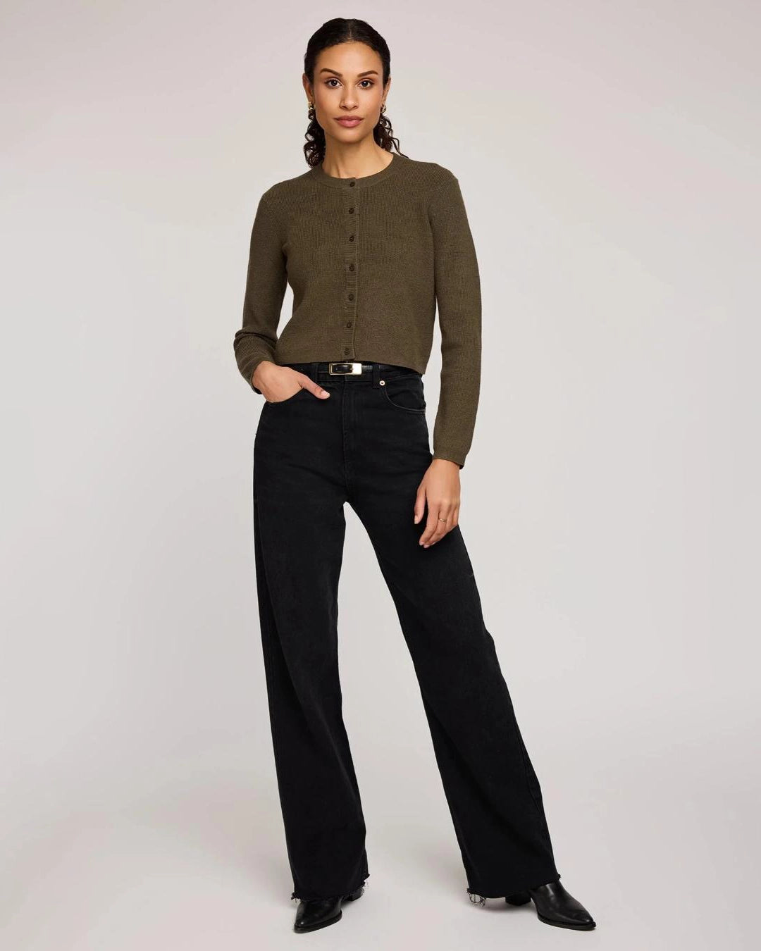 Woman wearing a green button down cropped cardigan