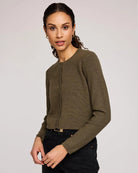 Woman wearing a green button down cropped cardigan