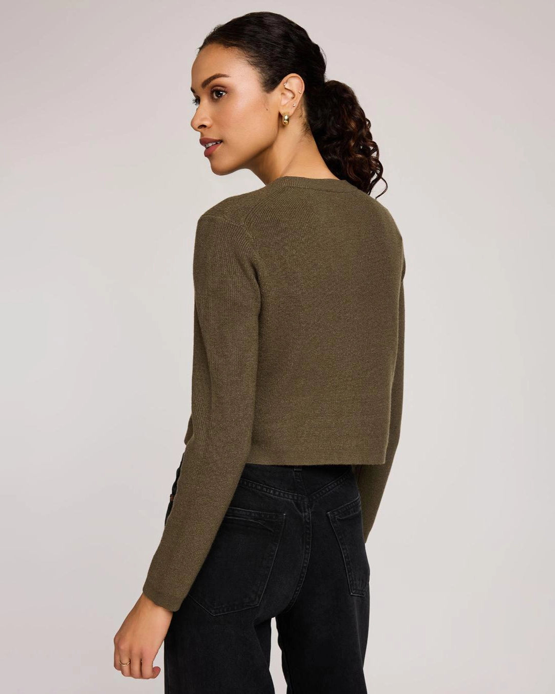 Woman wearing a green button down cropped cardigan