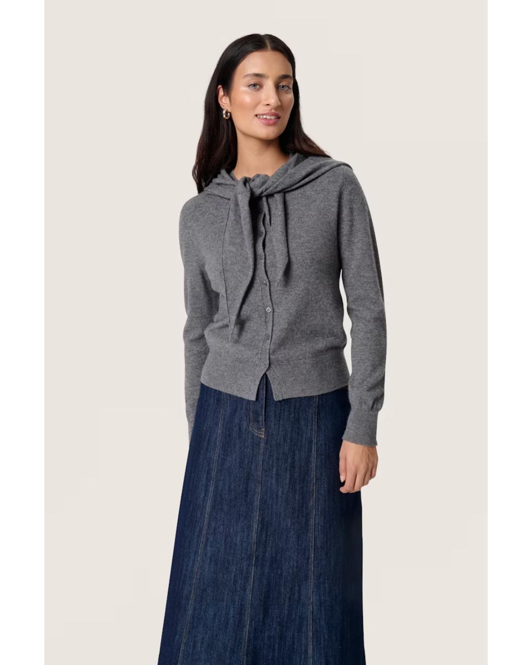 grey cardigan with a scarf attached over the shoulders 